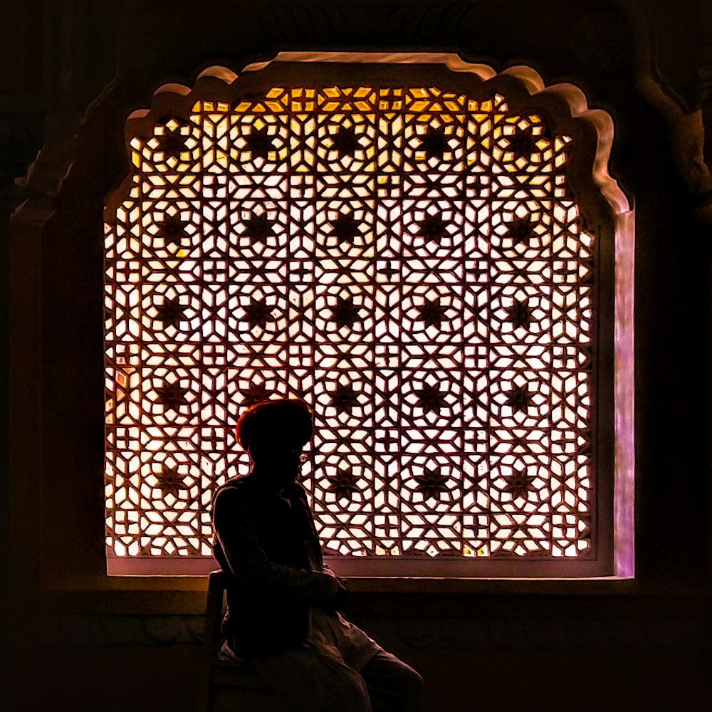 a person sitting in front of a window