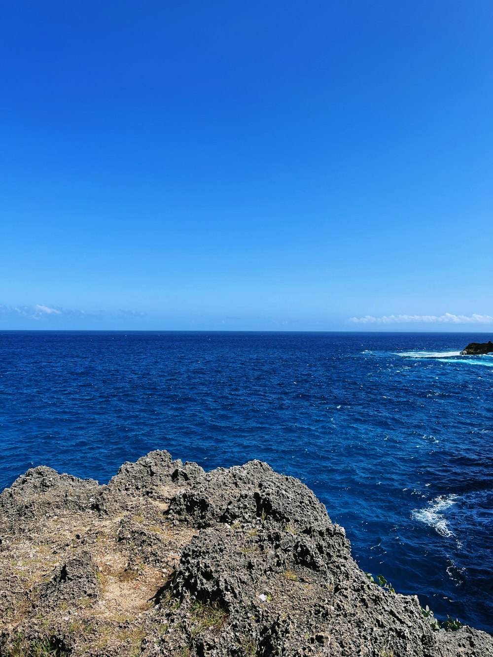 a rocky beach with blue water