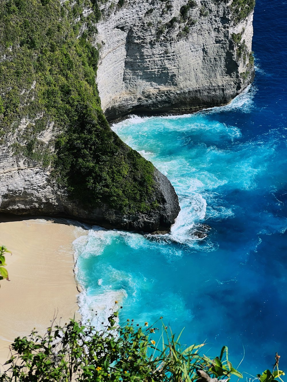 a rocky beach with a body of water and a sandy beach