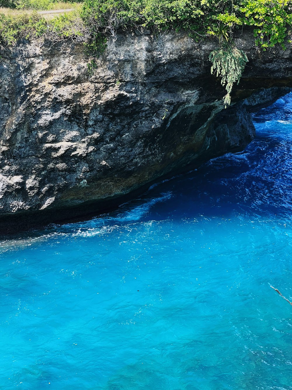 a large rock in the water