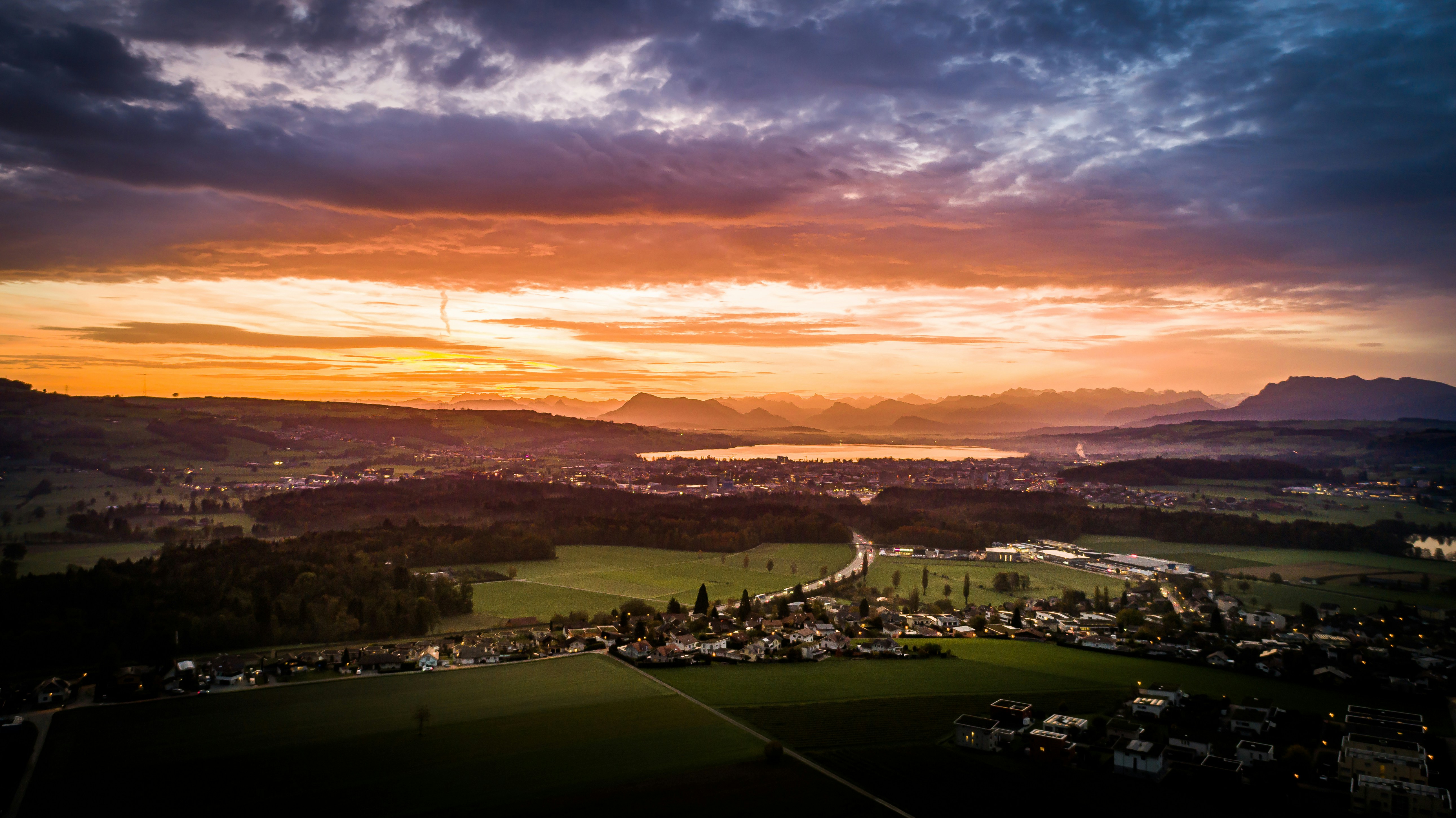 Sempach, Switzerland - 500 meters above ground - drone shot of an impressive sunrise in autumn.