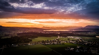 A scenic sunset over a picturesque lake in the Polish countryside.