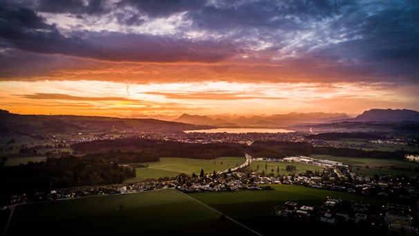 A scenic sunset over a picturesque lake in the Polish countryside.