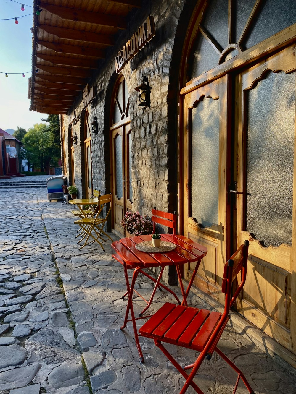 a table and chairs outside a building