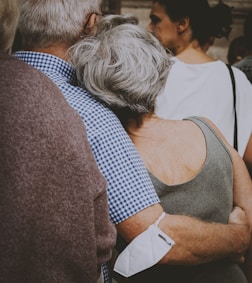 a woman with her arms around a man