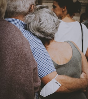 a woman with her arms around a man