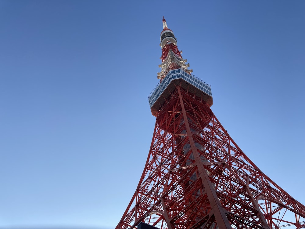 a tall metal tower with Tokyo Tower in the background