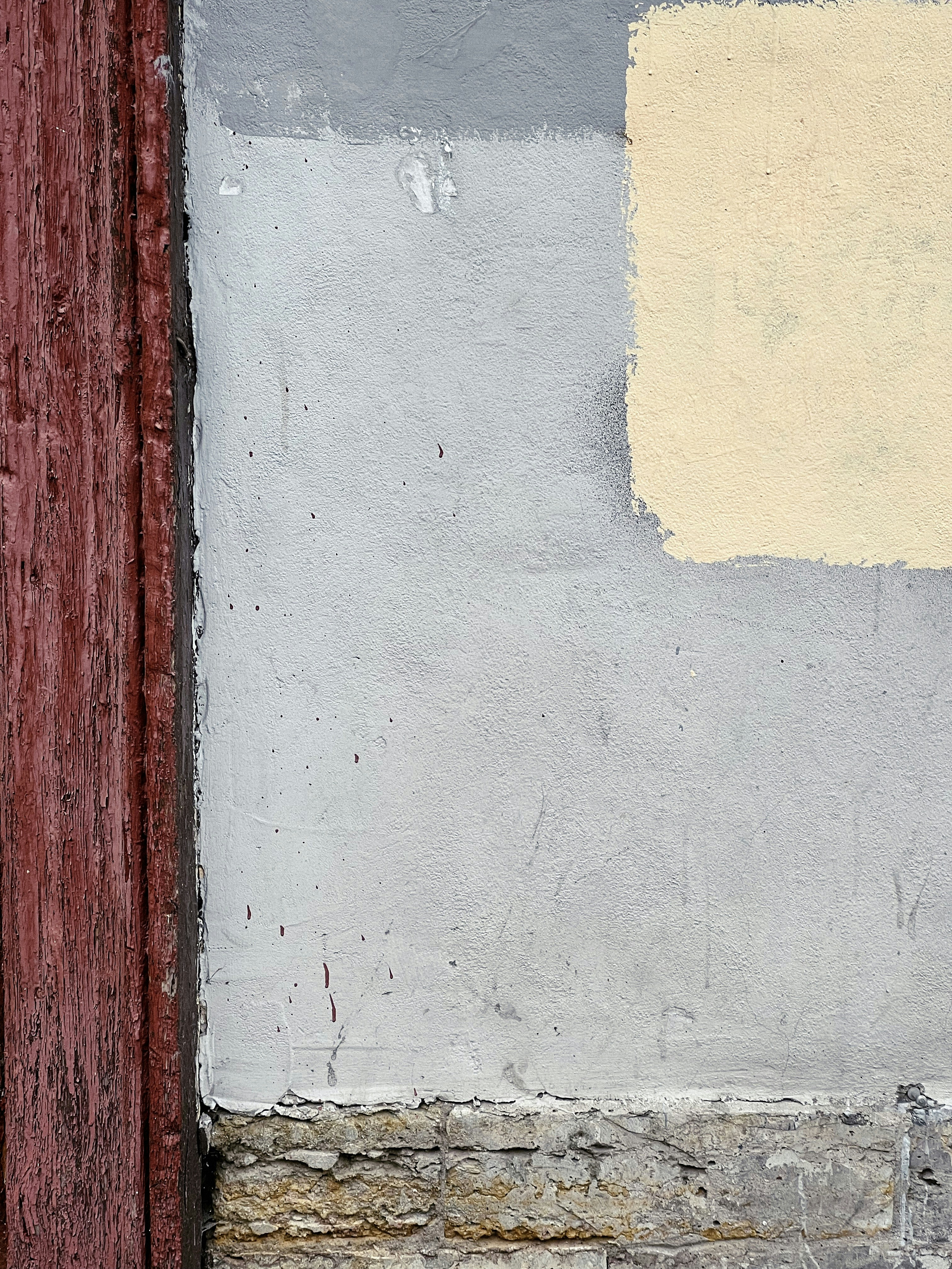 a white wall with a brown door