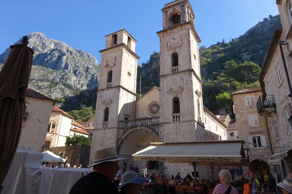 a large building with a clock tower with Kotor Cathedral in the background