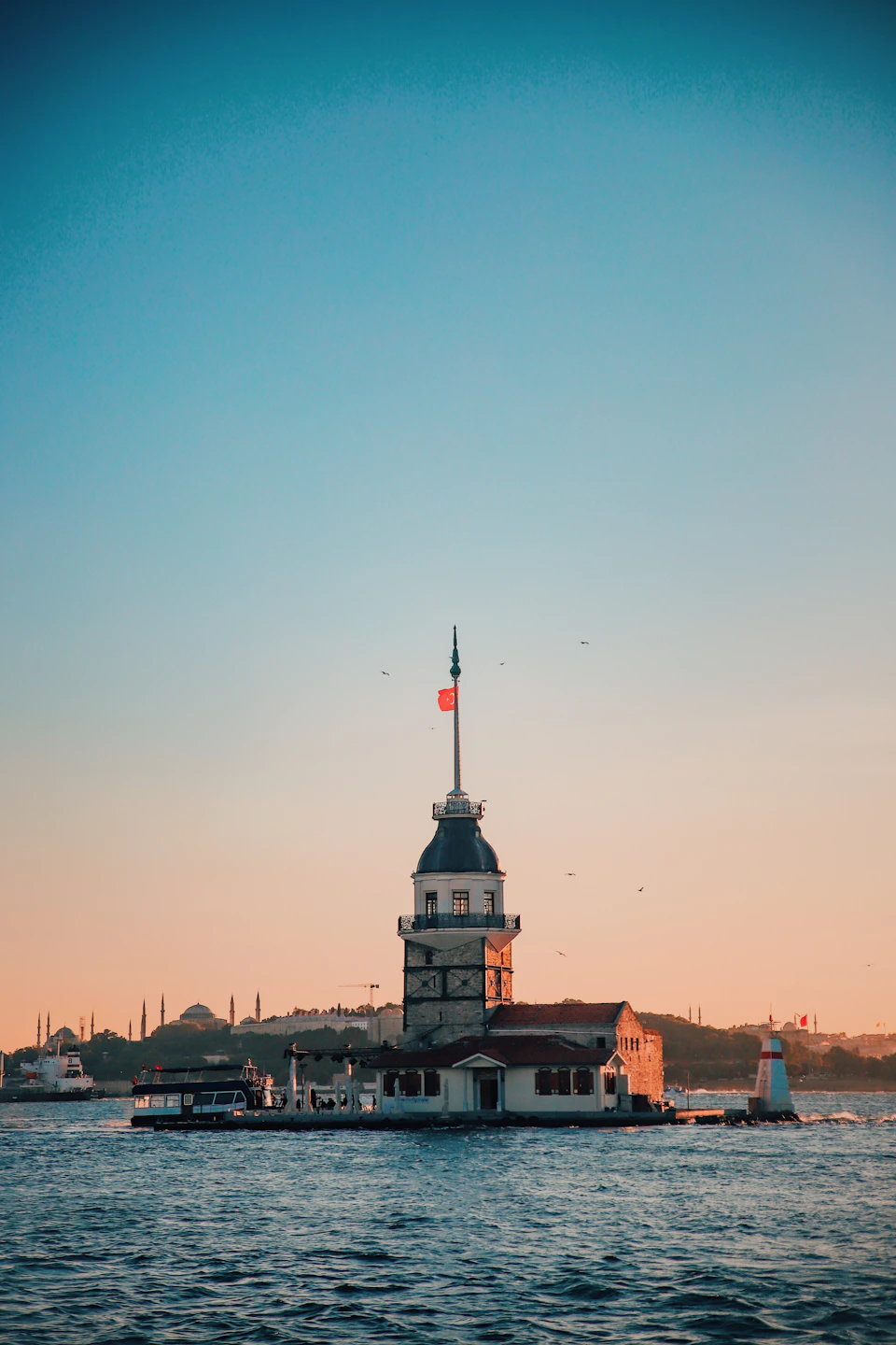 Serene scene at Bosphorus strait featuring Sultanahmet Tower in Istanbul, Turkey, with sailboat nearby