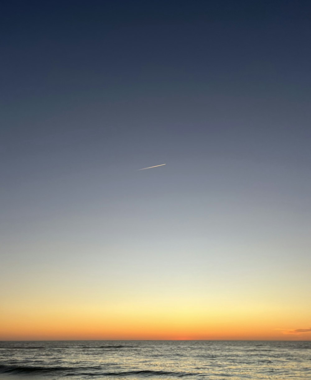 a plane flying over the ocean