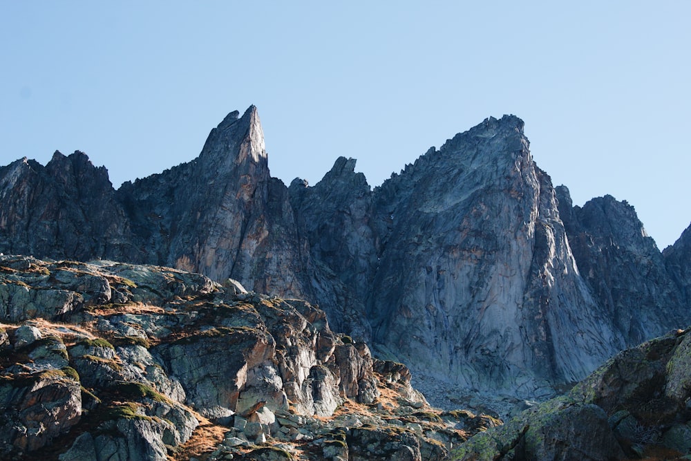 a rocky mountain with a blue sky