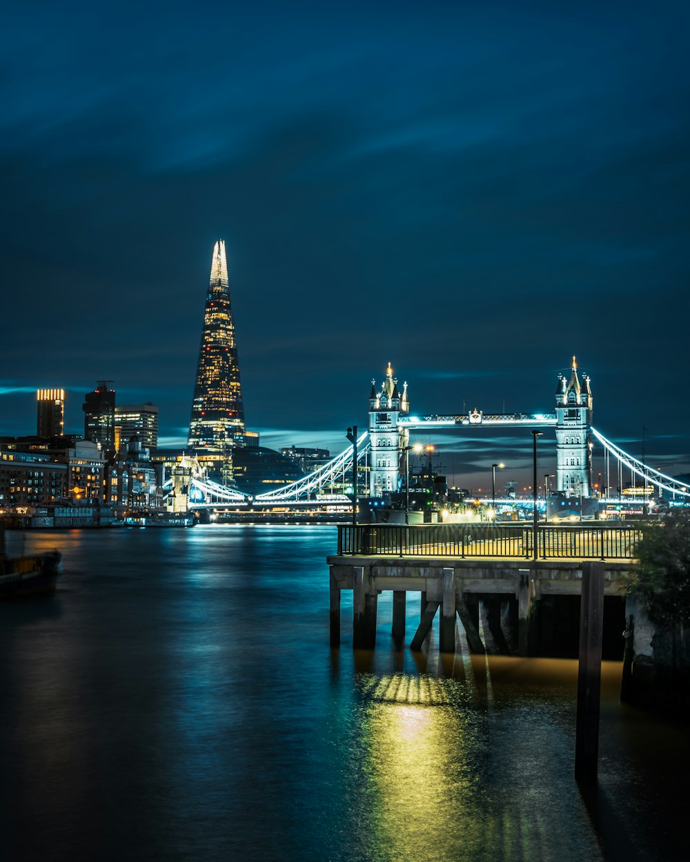 a bridge over water with a city in the background