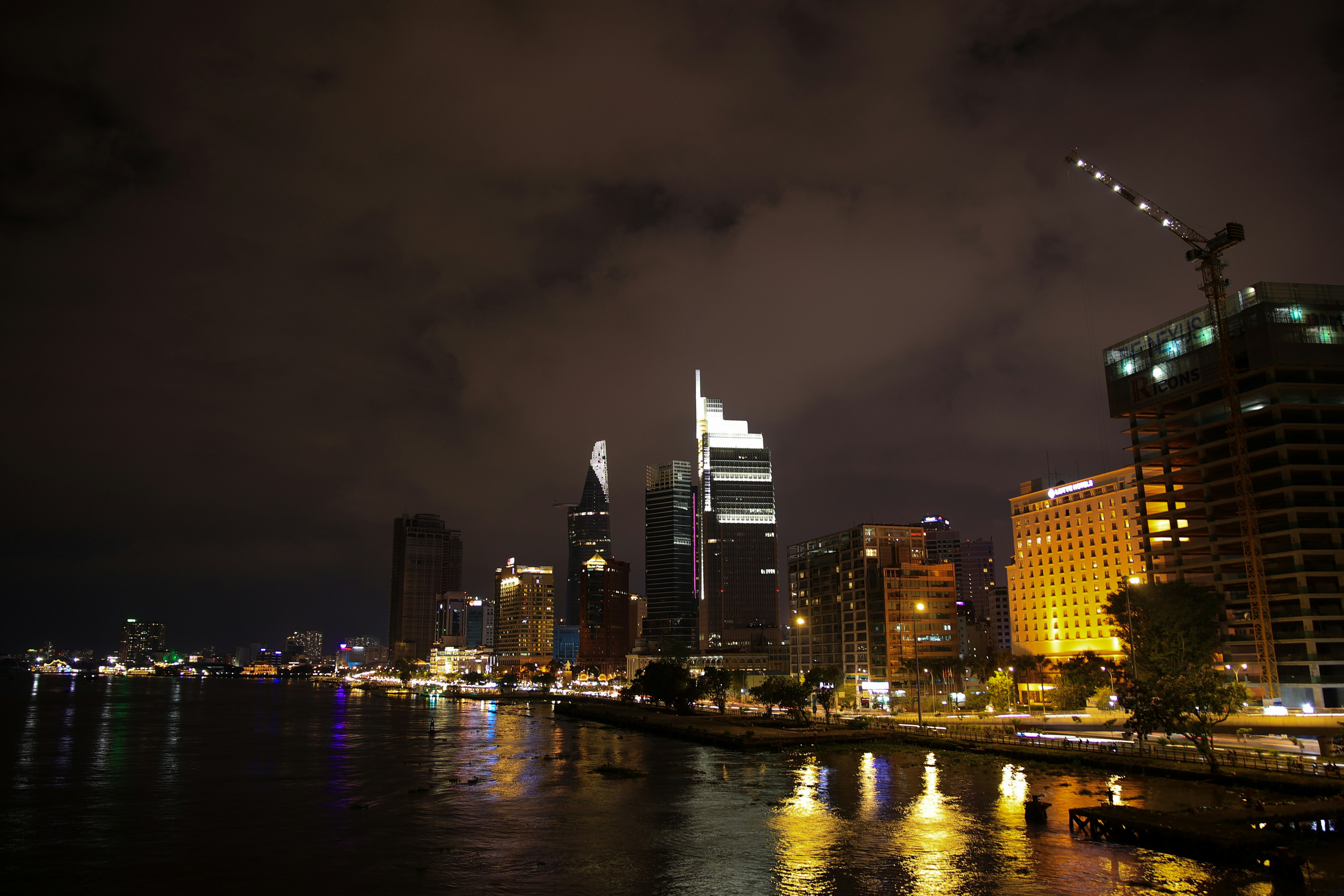 Dark urban night scene with neon reflections and streaming data visualization