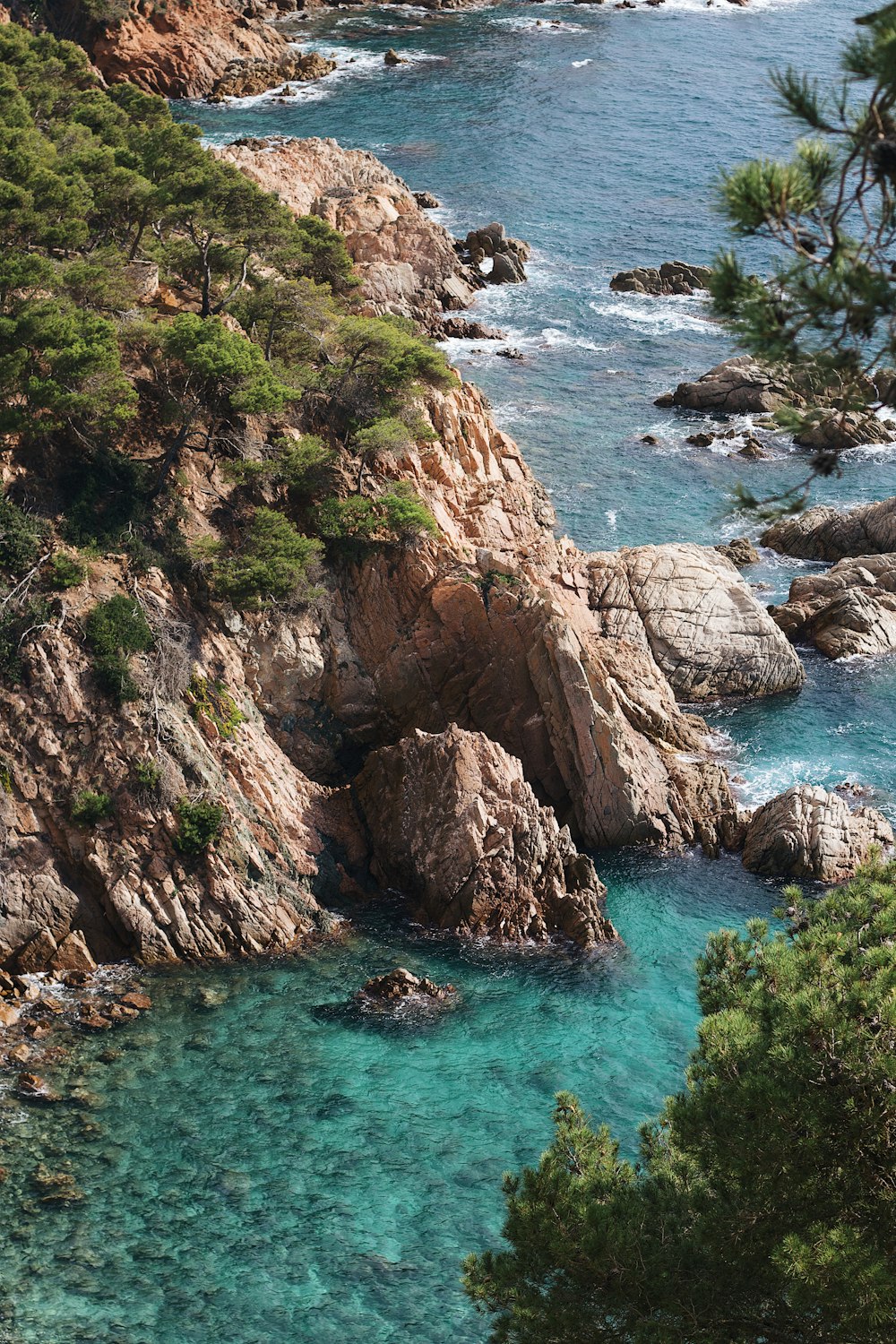 a rocky cliff with a body of water below