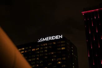 Elegant exterior view of Le Meridien Tower hotel in Makkah glowing at night.