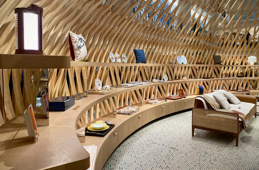 Warm private jewelry salon with curved wooden walls and display cases
