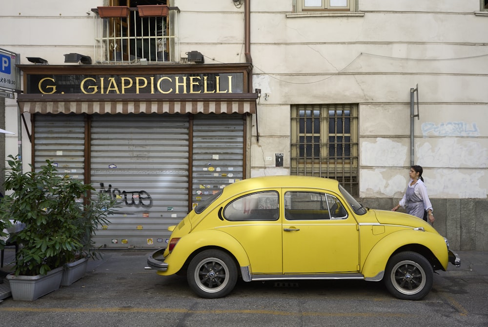 a yellow car parked in front of a building