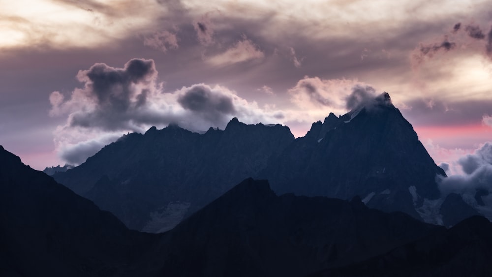 a mountain with clouds above it