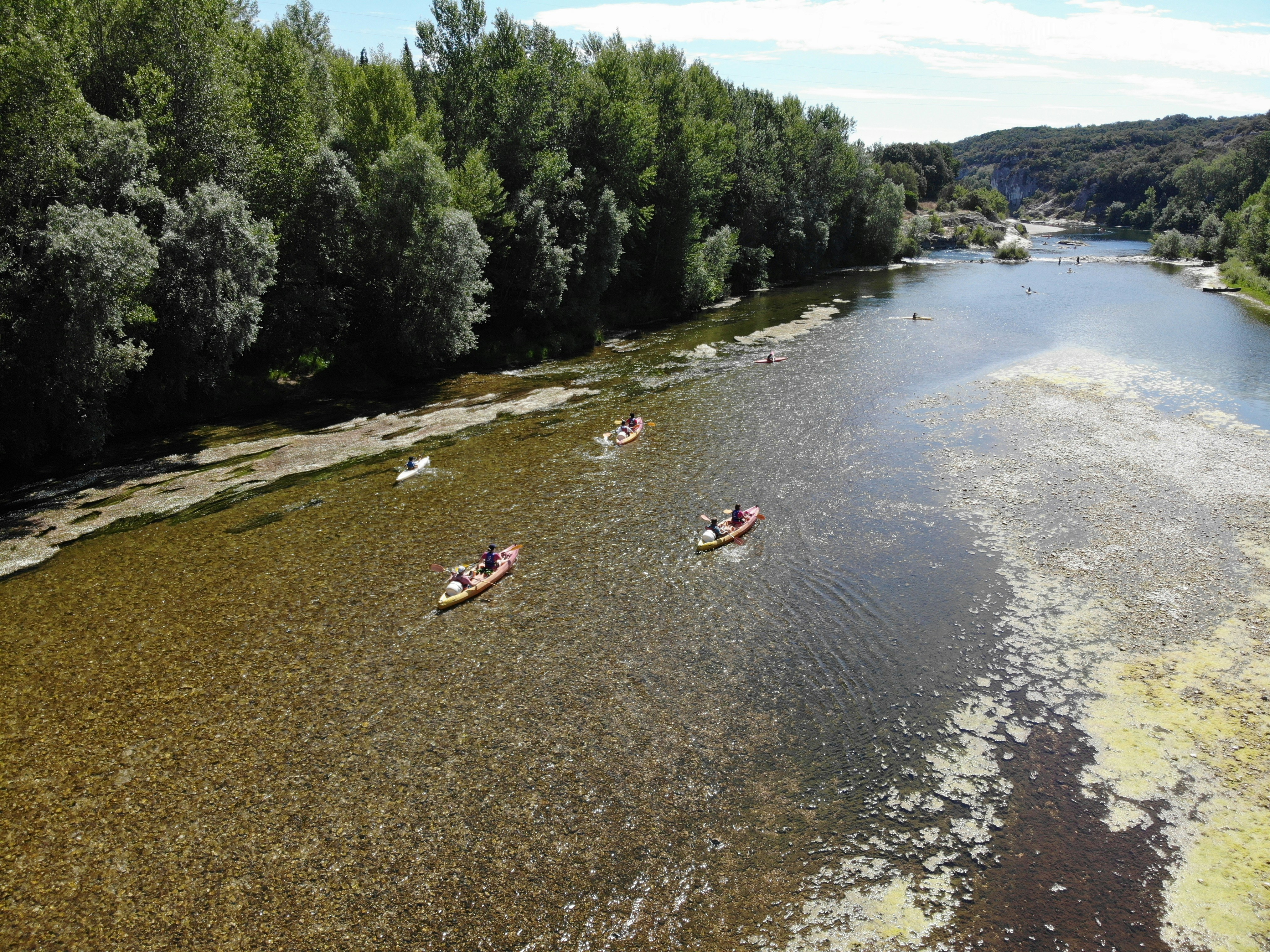 a group of people in canoes on a river