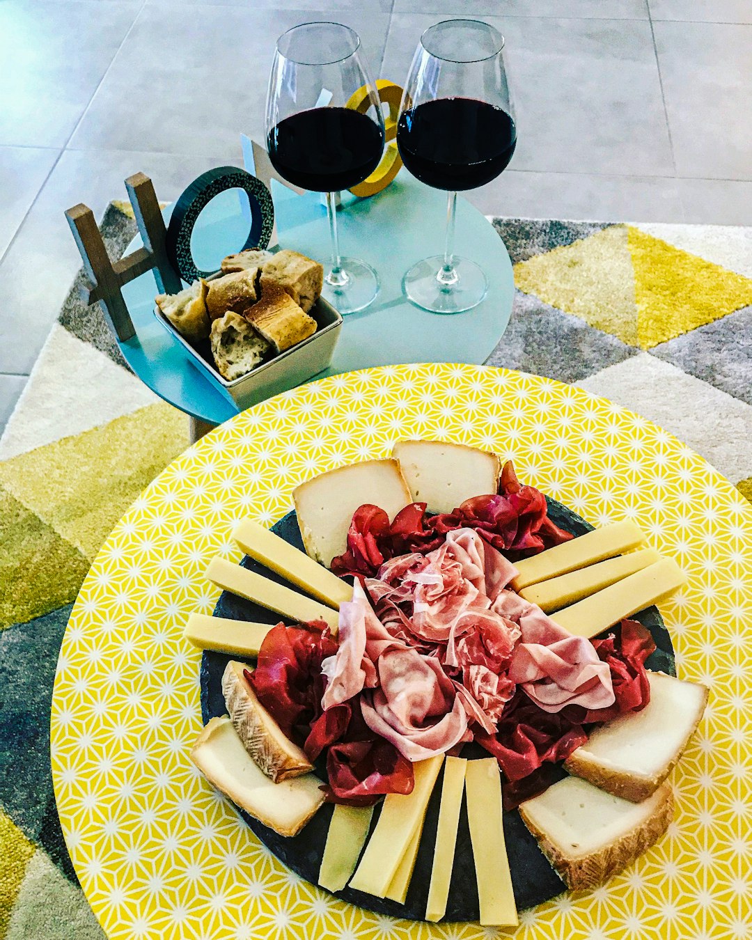 a plate of cheese and wine