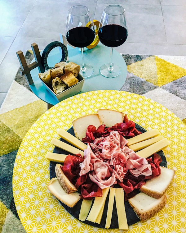A plate of cheese and wine
