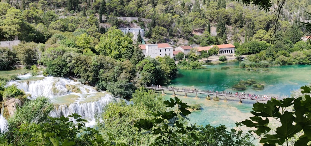 a river with a bridge and a house on the other side