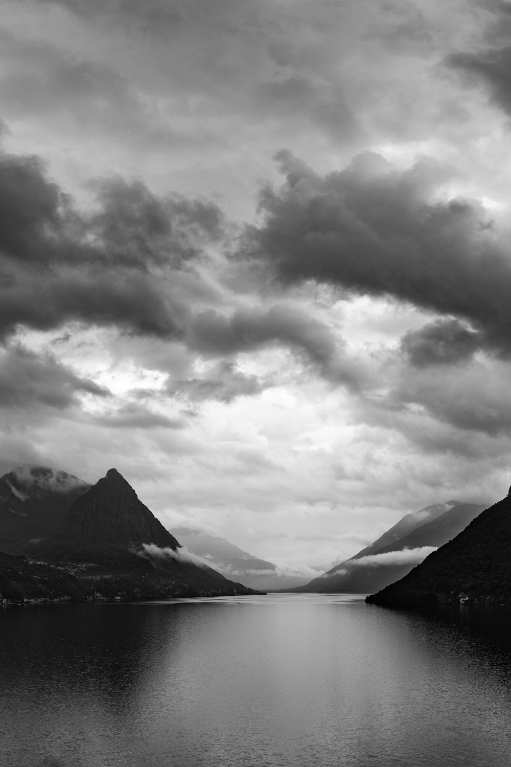 a body of water with mountains in the background