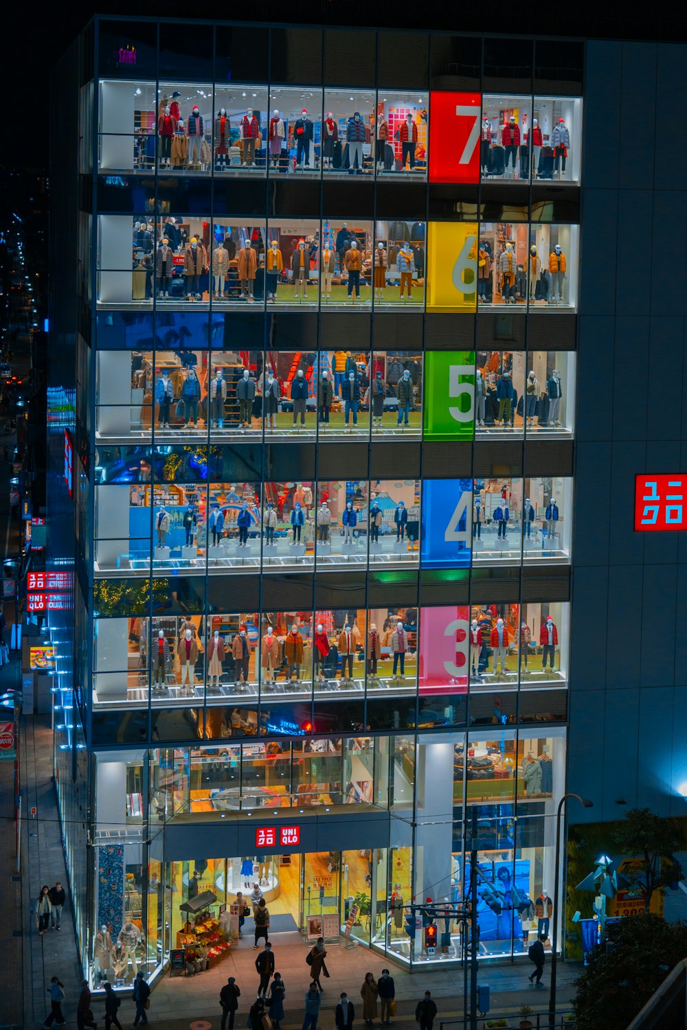 a building with many windows and people walking around