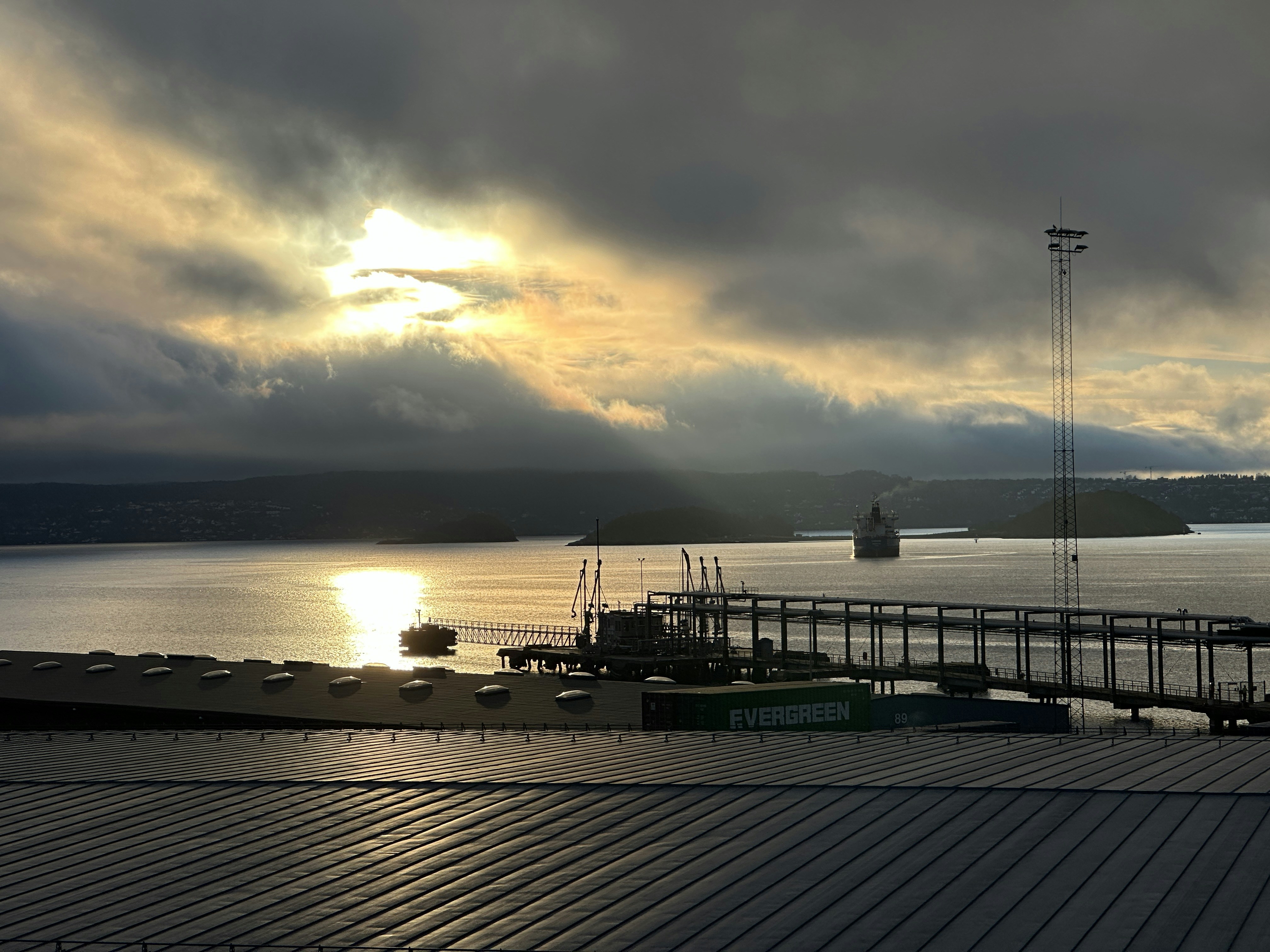 a dock with boats and a sunset