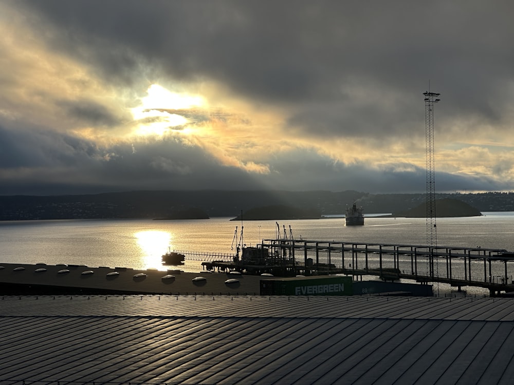 a dock with boats and a sunset