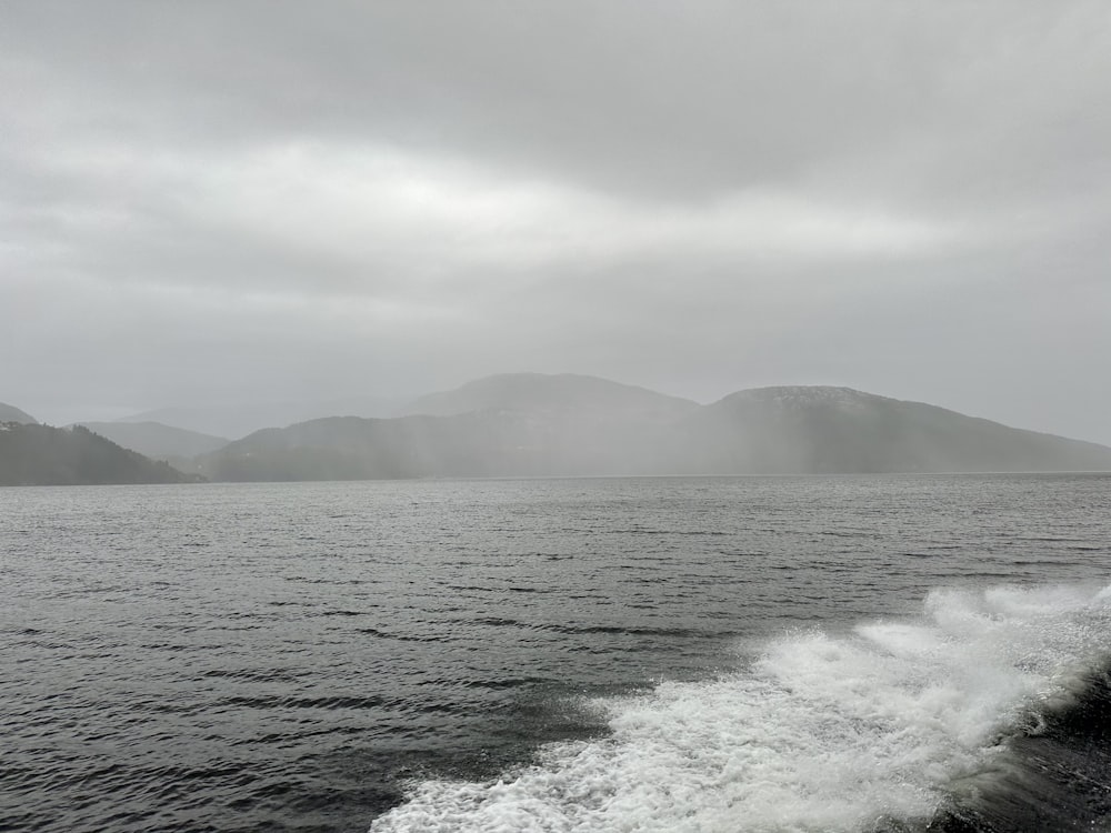 a body of water with hills in the background