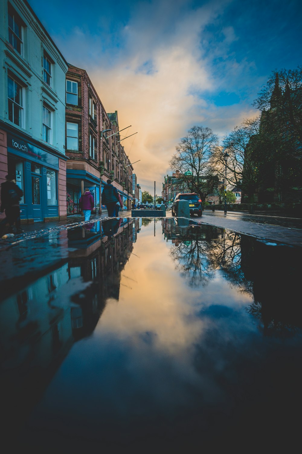 a canal with buildings and a bus