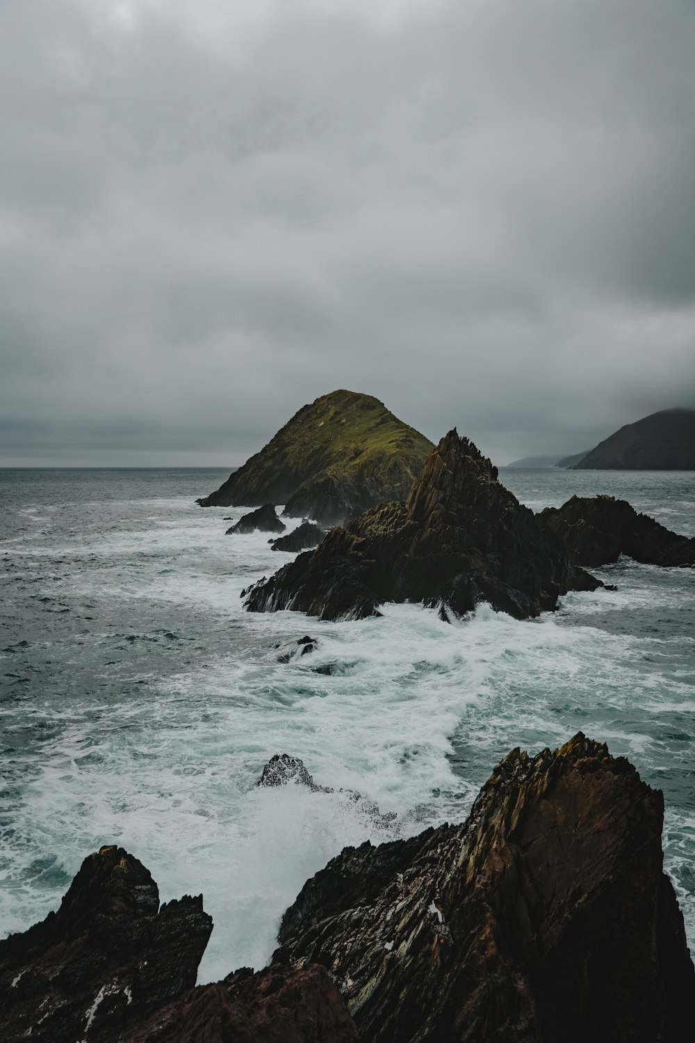 a rocky beach with waves crashing against it