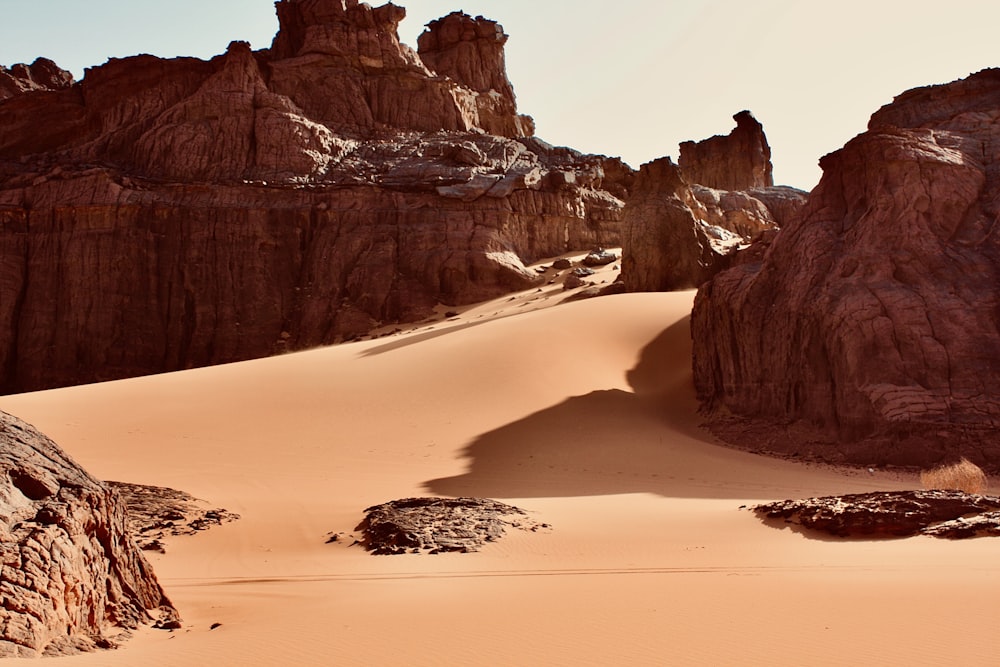 a sandy beach with large rocks