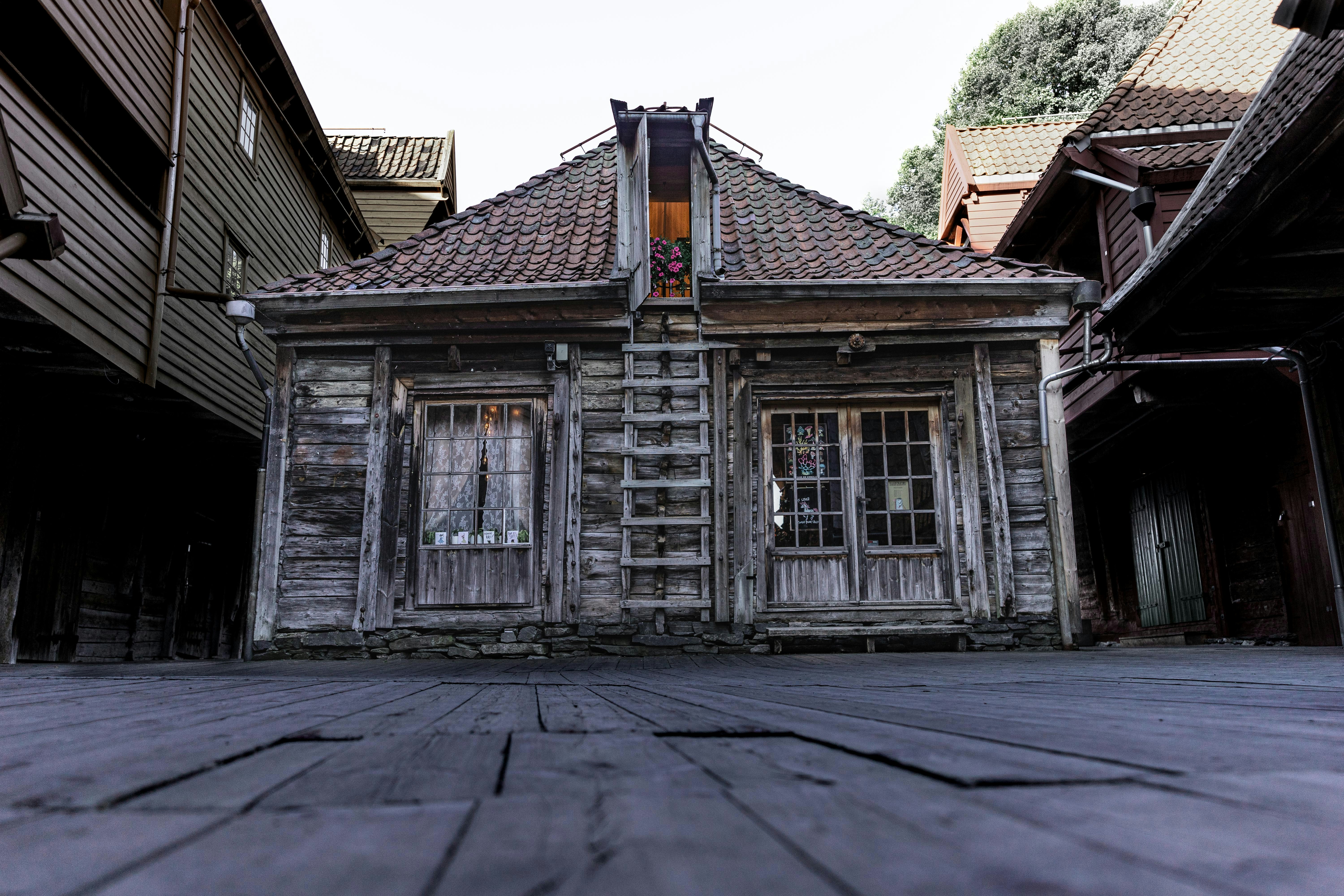 A close-up shot of an old, intricate Goan-Portuguese style house with visible signs of aging but also unique architectural beauty.