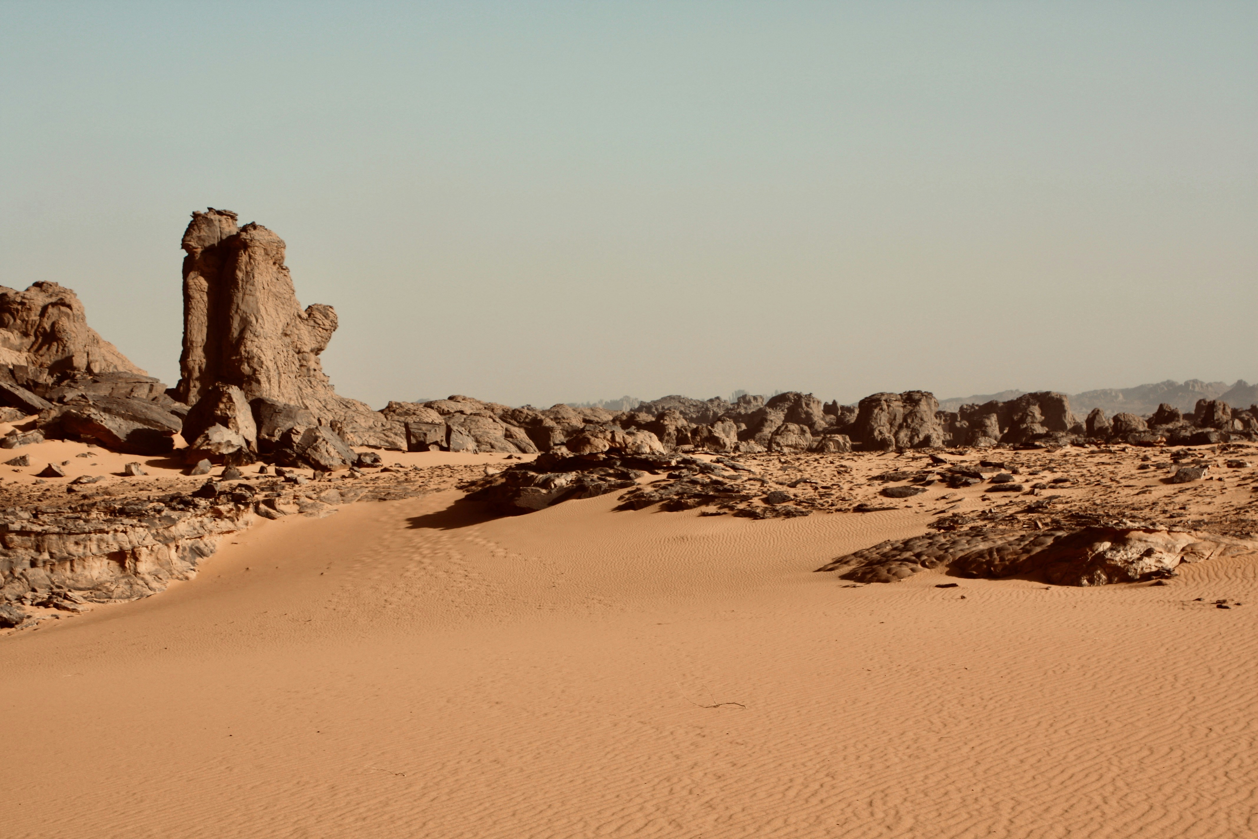 A desert landscape with a few large rocks