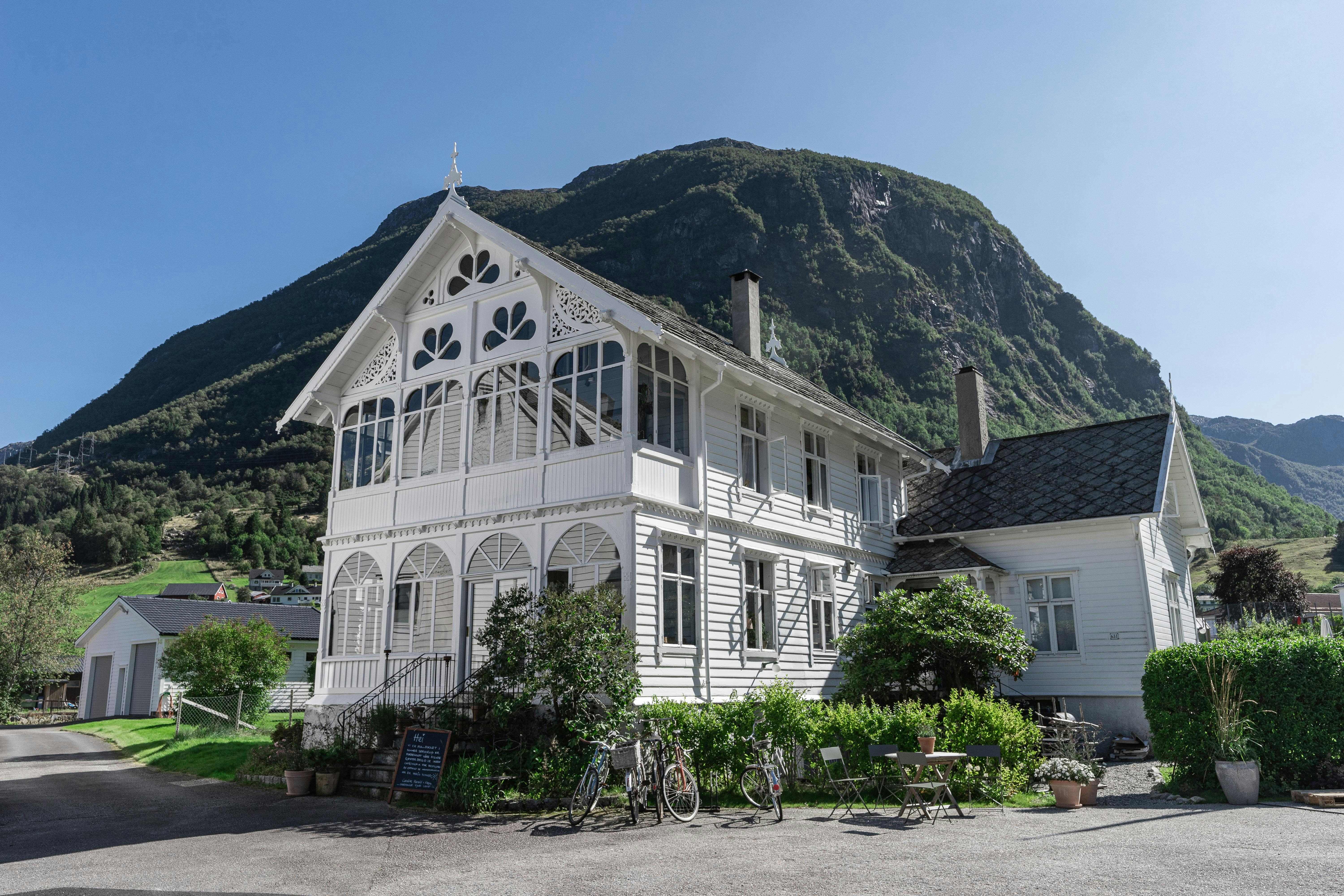 a white building with a mountain in the background