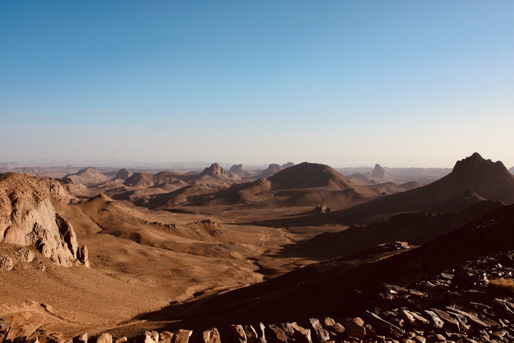 a rocky landscape with mountains in the background