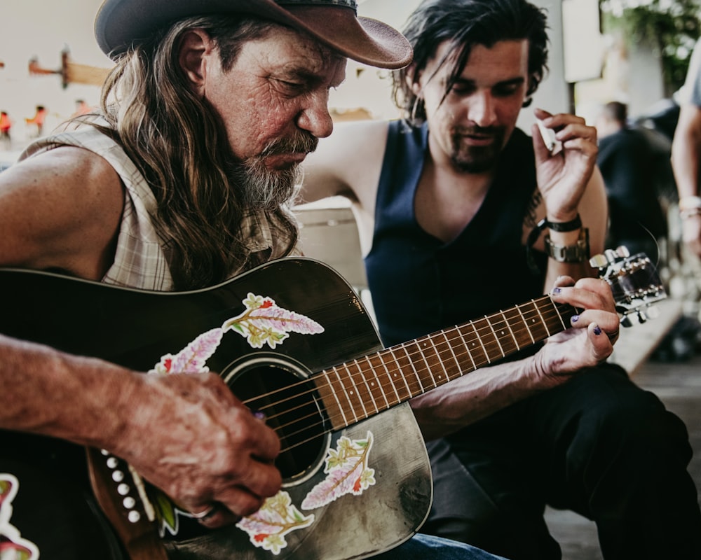 a couple of men playing guitars