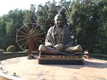 a statue of a man sitting on a bench