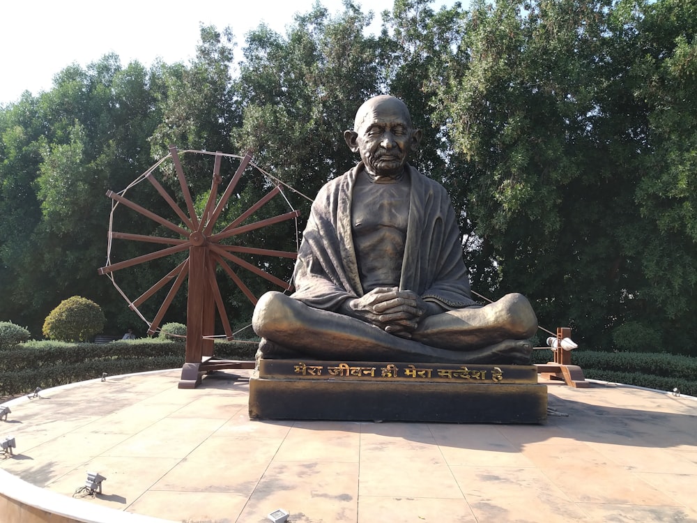 a statue of a man sitting on a bench