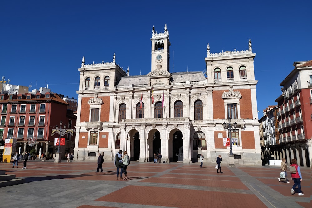 a large white building with a clock tower