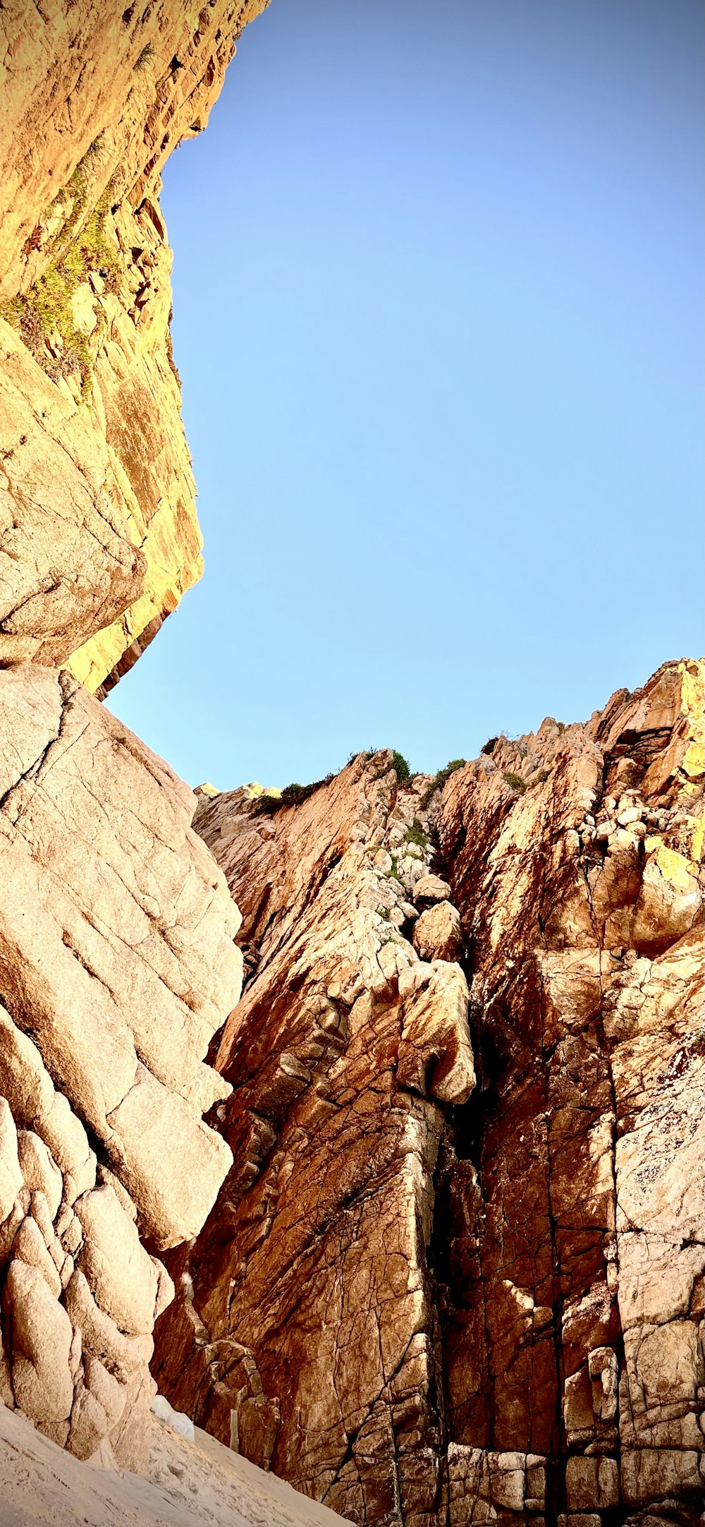 a rock wall with a blue sky