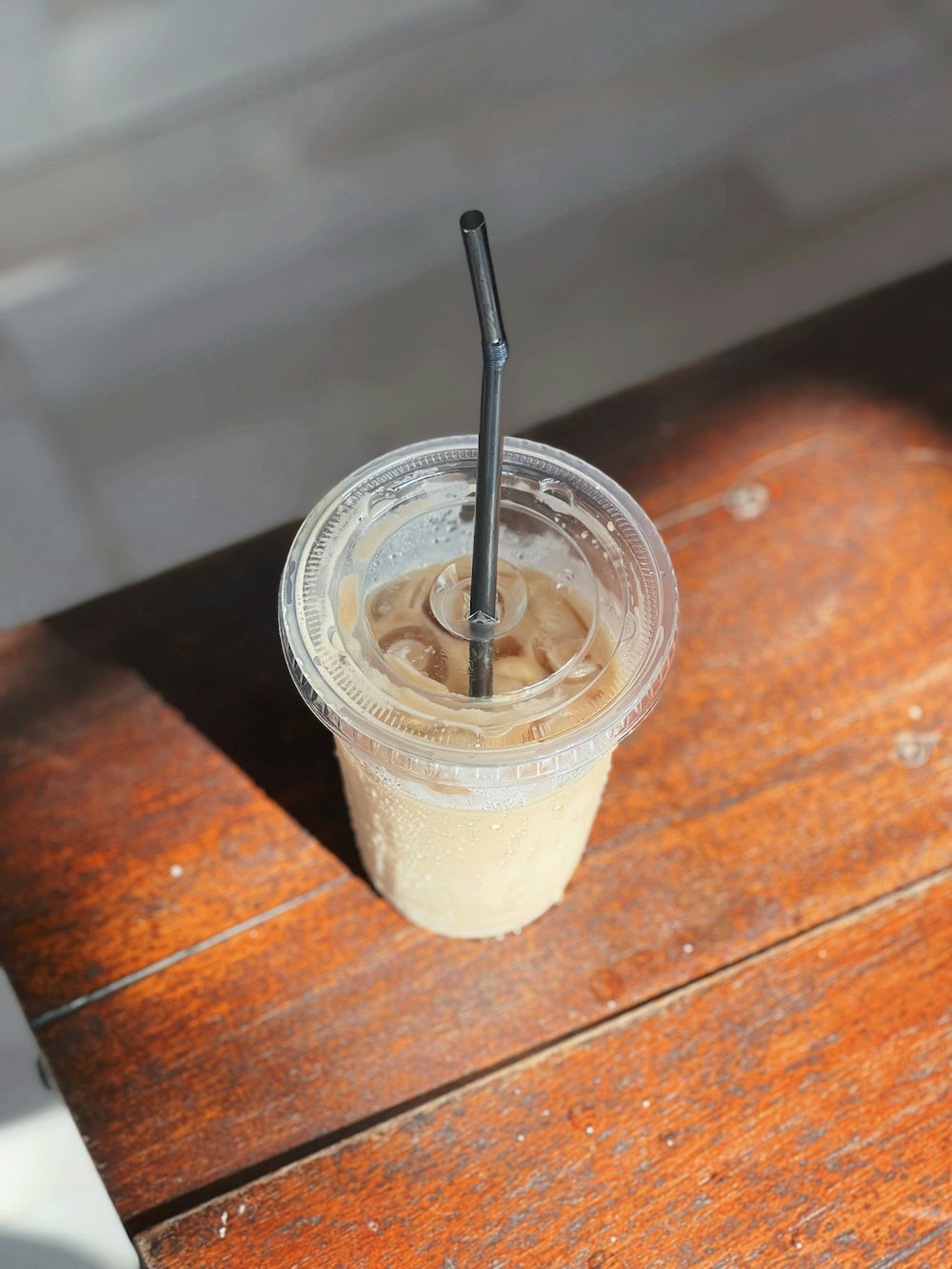 a plastic cup with a straw