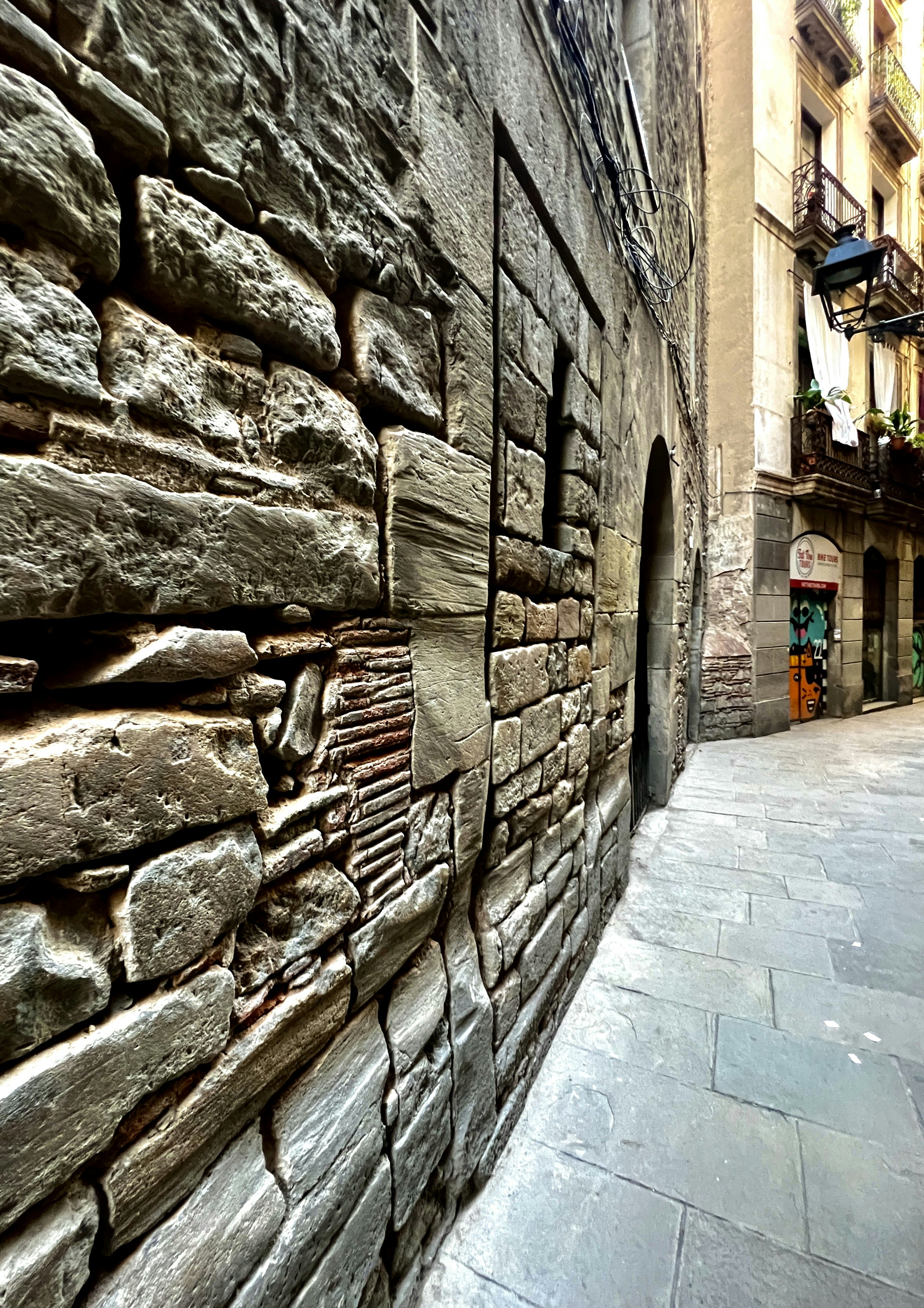 a stone street with a stone wall