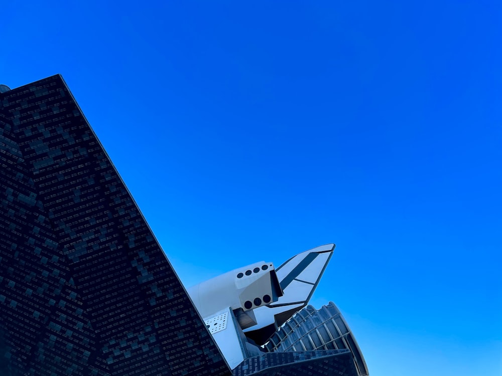 a plane flying in front of a couple of skyscrapers