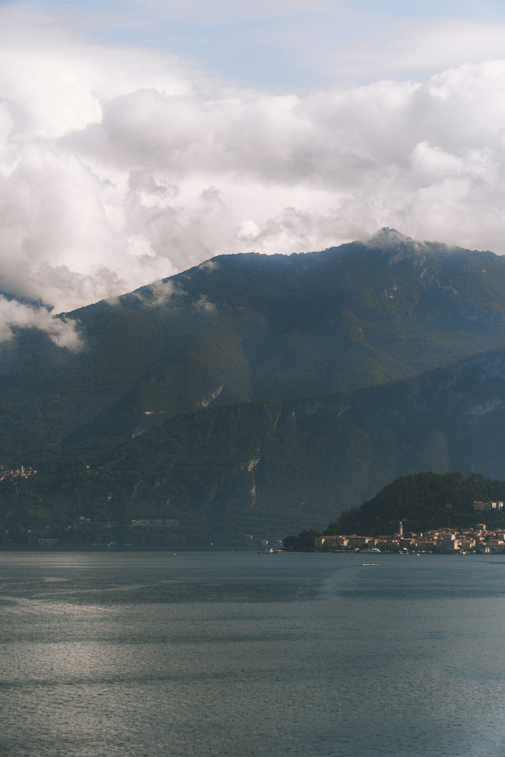 a body of water with a mountain in the background