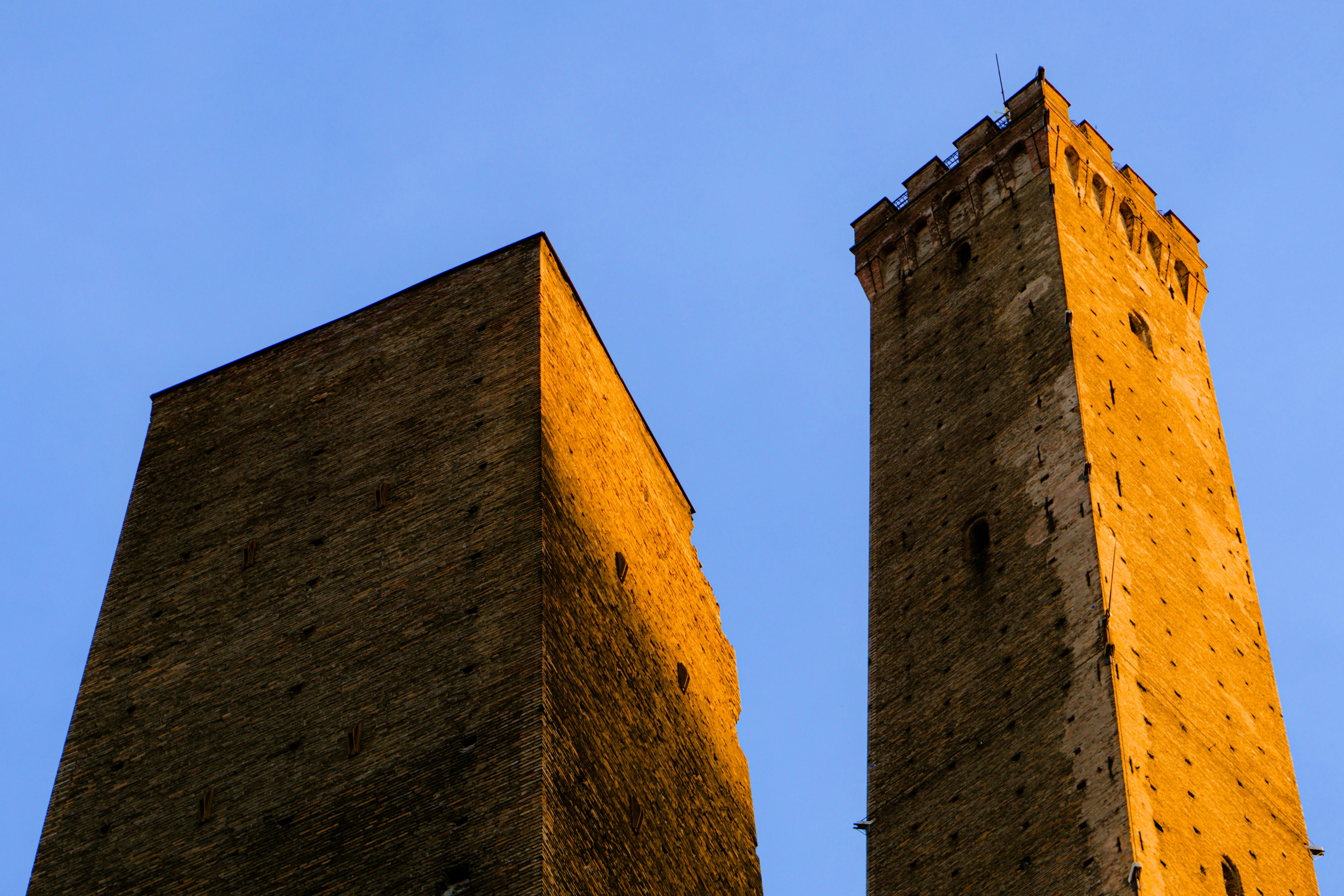 two stone towers with a blue sky
