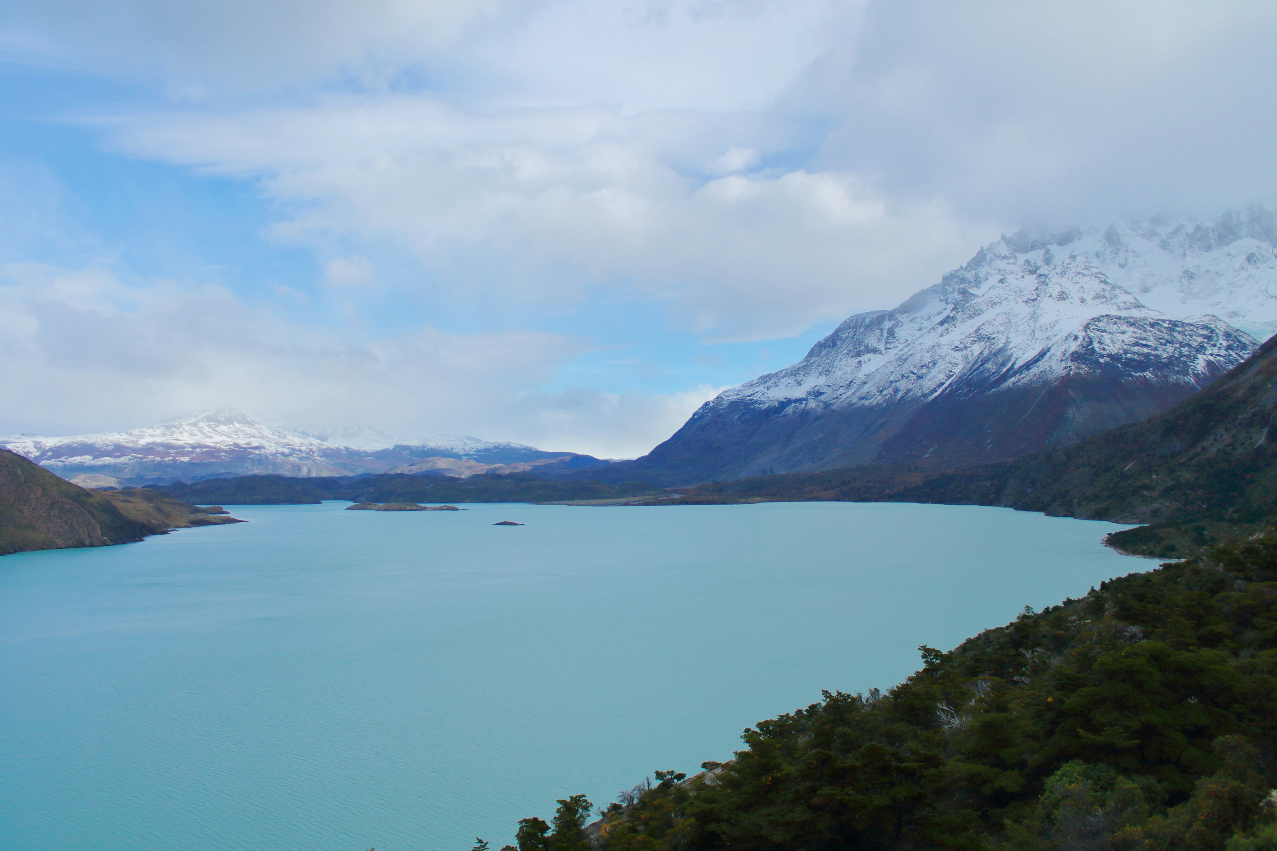 a body of water with mountains in the back